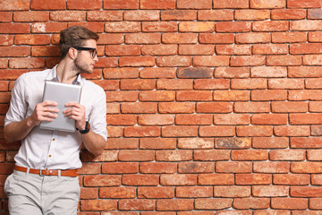 Attractive male student using modern gadget