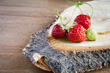 Fresh ripe organic strawberry on wooden background. Rustic style.