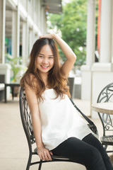 Asian beautiful girl raise hand higher and put hand over head an