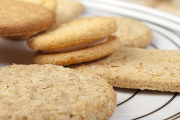 Fototapeta na wymiar Close up of a plate of assorted fresh crisp biscuits