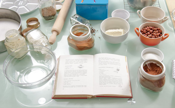 Cooking book on table full of bowls
