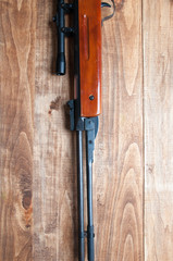 Air rifle isolated on wooden background