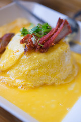 rice wrapped inside the omelette topping with roasted pork