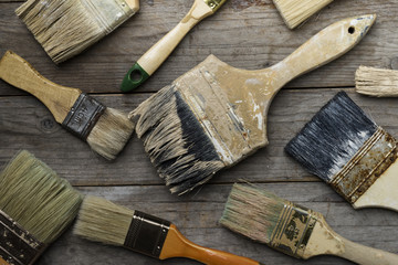 old brushes on the wood table - Powered by Adobe