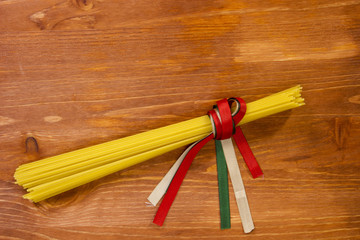 Pasta spaghetti tied with ribbons of the flag colors of Italy
