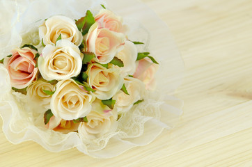 Satin Rose Bouquet on Pine Wood Background.