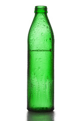 Green bottle with liquid and water droplets