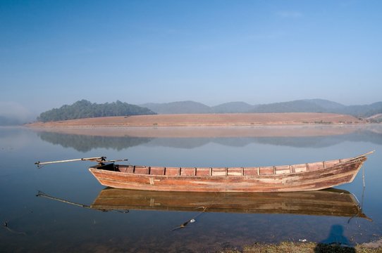 Wooden boat of fisher in Golden lake (Ho Suoi Vang), Dalat, Vietnam