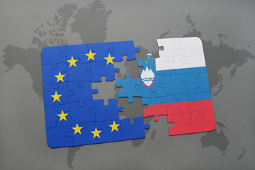 puzzle with the national flag of slovenia and european union on a world map background.