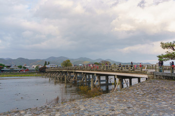 Fototapeta na wymiar Kyoto, Japan - December 3, 2015: Katsura River and Togetsukyo Bridge in Arashiyama, Kyoto, Japan