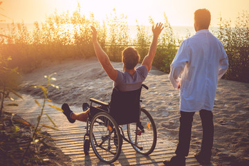 A man on wheelchair and his nurse.