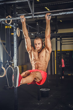 Male doing exercises on horizontal bar.