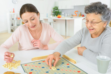 Elderly woman playing a board game