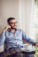 Young Handsome Man Using Mobile Phone Indoor