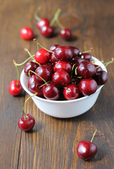 Sweet cherry in bowl on the table.