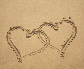 two hearts on sandy beach