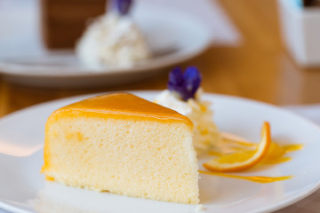 Orange cake on white plate. (Selected focus)