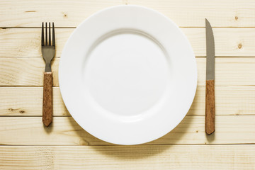 Empty Plate And Cutlery On The Wooden Table./Empty Plate And Cutlery On The Wooden Table