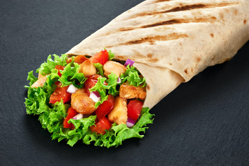 Burrito with grilled chicken and vegetables (fajitas, pita bread