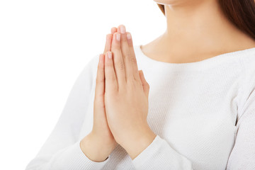 Beautiful young caucasian woman praying