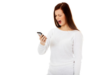 Fototapeta premium Young student woman yelling to the mobile phone