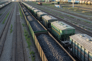 trains with industrial goods stand on the rails