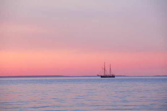 Fototapeta Yacht swimming in Baltic sea at sunset