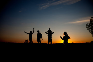 Fototapeta na wymiar silhouette of family on the outdoor at dusk.