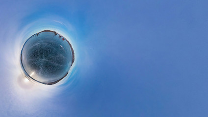Tourists make the transition ice on Lake Baikal ice at sunset. W