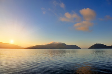 Beautiful morning seascape with mountains in the background
