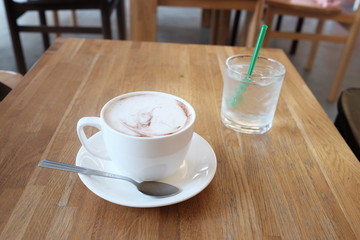 hot fresh coffee in white cup on wooden table with cold glass of water cappuccino coffee mocha coffee espresso coffee latte coffee
