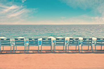 Line of blue chairs on the English Promenade in the city of Nice, France