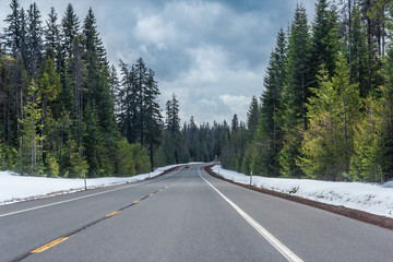 Highway running through forests of Oregon covered with snow,  USA