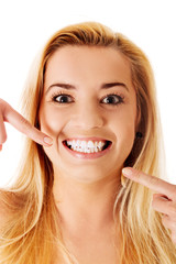 Woman showing her perfect straight white teeth.