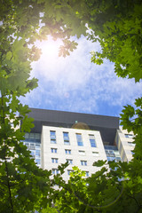 multistorey residential building surrounded by green trees