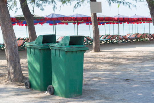 Green trash bin near the beach