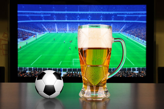 Pint of beer and soccer ball
