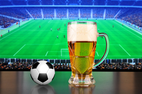 Pint of beer and soccer ball