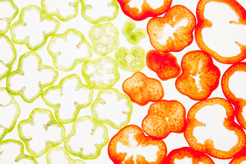 Sliced green and red pepper rings  on a white background. Decorative pattern. Food background. Concept art.