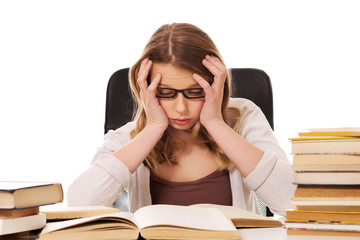 Young woman with a books pile