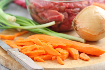 Sliced onion and carrot on chopping board