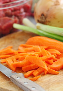 Sliced onion and carrot on chopping board