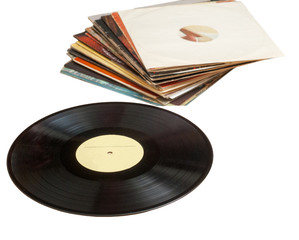 Fototapeta premium Vinyl record with copy space in front of a collection albums dummy titles, isolated on white background. vintage process