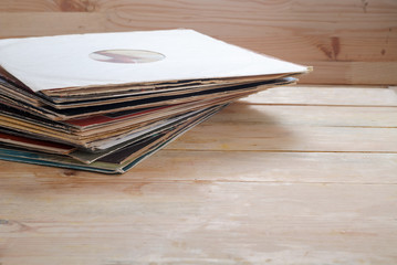 Naklejka premium Vinyl record with copy space in front of a collection albums dummy titles, vintage process