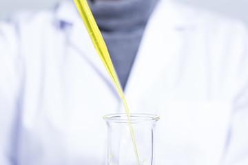 Woman Sciencetist: Researcher Holding at a Liquid Solution on Is