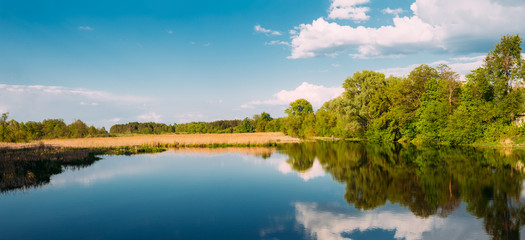 River Landscape With Clouds Reflected In The Water. Sunny Summer