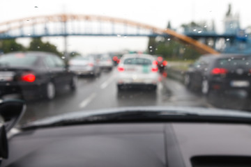 Driving a car in bad weather conditions in traffic jam - blurred view
