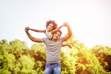 Fototapeta premium Father carrying daughter piggyback