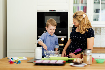 Beautiful child and mother baking