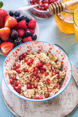 granola bowl with pommegranate seeds